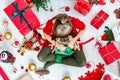 Cute Girl Sitting on the Floor Opening Christmas Present. Royalty Free Stock Photo