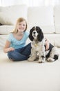 Cute Girl Sitting With Pet Dog In Living Room Royalty Free Stock Photo