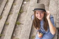 Cute girl sitting on the stone steps, top view, looking at the camera. Royalty Free Stock Photo