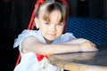 cute girl sitting at a table in kafe in the summer Royalty Free Stock Photo