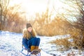 Cute girl sledding in a snowy winter park. Children have fun and have fun Royalty Free Stock Photo