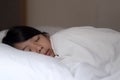 Cute girl sleeping on white pillow at home