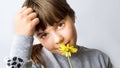 Cute girl smelling yellow spring flower Royalty Free Stock Photo