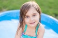 Girl smiling in kiddie pool