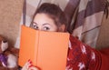 Cute girl on the sofa with a book Royalty Free Stock Photo