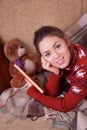 Cute girl on the sofa with a book Royalty Free Stock Photo