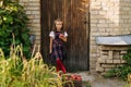 Cute Girl Stand At Wooden Door House Background