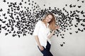 Cute girl standing on a fantastic background with lots of butterflies