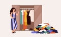 Cute girl standing in front of opened wardrobe with apparel hanging inside and pile of clothes on floor. Concept of Royalty Free Stock Photo