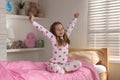 Cute girl stretching on bed at home Royalty Free Stock Photo