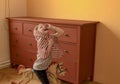 Cute girl swings on rocking horse. Small girl plays and acts like princess.