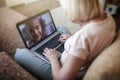 Cute girl talking with her grandmother within video chat on laptop, life in quarantine time Royalty Free Stock Photo