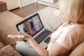 Cute girl talking with her grandmother within video chat on laptop, life in quarantine time Royalty Free Stock Photo