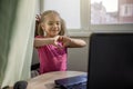 Cute girl talking with her grandmother within video chat on laptop, life in quarantine time Royalty Free Stock Photo