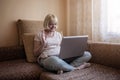 Cute girl talking with her grandmother within video chat on laptop, life in quarantine time Royalty Free Stock Photo