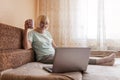 Cute girl talking with her grandmother within video chat on laptop, life in quarantine time Royalty Free Stock Photo