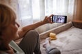 Cute girl talking with her grandmother within video chat on laptop, life in quarantine time Royalty Free Stock Photo