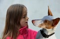 Girl talks to her podenco. The dog listens attentively