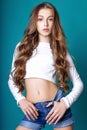 Cute girl teenage with long curly hair posing studio nature portrait. Royalty Free Stock Photo