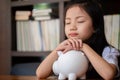 Cute girl tired sleep on piggy bank,saving money concept