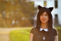 Cute girl with toy cat ears on head in sunbeam light Royalty Free Stock Photo