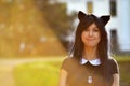 Cute girl with toy cat ears on head in sunbeam light Royalty Free Stock Photo