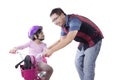 Cute girl trains to ride a bicycle with dad Royalty Free Stock Photo