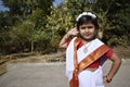 A cute and innocent village girl standing in front of the garden