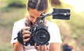 Cute girl shooting a video with a professional video camera Royalty Free Stock Photo