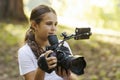 Cute girl shooting a video with a professional video camera Royalty Free Stock Photo