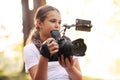 Cute girl shooting a video with a professional video camera Royalty Free Stock Photo