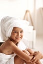 Cute girl wearing a bathrobe with wet hair after bath or shower, laughing and smiling Royalty Free Stock Photo