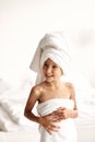 Cute girl wearing a bathrobe with wet hair after bath or shower, laughing and smiling Royalty Free Stock Photo