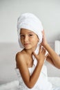 Cute girl wearing a bathrobe with wet hair after bath or shower, laughing and smiling Royalty Free Stock Photo