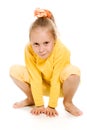 Cute girl in a yellow smiling sitting on the floor