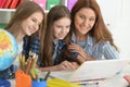Cute girls with mother on lesson with laptop Royalty Free Stock Photo