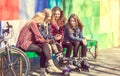 Cute girls sitting on the bench in the park and laughing Royalty Free Stock Photo