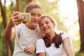 Cute girls taking selfies in the forest Royalty Free Stock Photo