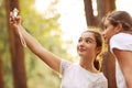 Cute girls taking selfies in the forest Royalty Free Stock Photo