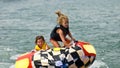 Cute Girls on Tube Behind Boat Royalty Free Stock Photo