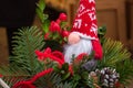 Cute gnome toy on Christmas tree. Small dwarf doll in red hat. Santa Claus doll on Christmas market. Christmas market. Royalty Free Stock Photo