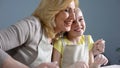 Cute granddaughter and her grandmother laughing and hugging while baking, family Royalty Free Stock Photo