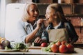 Cute Grandma and Granddaughter Cutting Vegetables