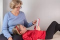 Cute grandmother is reading a book her granddaughter holding a book together, front view Royalty Free Stock Photo