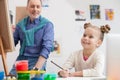 Cute grandparent and child are drawing with joy Royalty Free Stock Photo