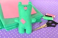 Cute green felt Teddy bear. Handmade children toy. Scissors, threads, needles. Sewing kit