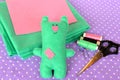 Cute green felt Teddy bear - handmade children toy. Scissors, threads, needles - sewing kit