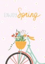Cute greeting card on pink background. Basket with flowers on the bicycle. Spring holidays concept.