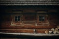 Cute grey cat sitting near old wooden house in Scandinavia, norw Royalty Free Stock Photo