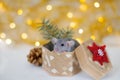 Cute grey little rat looking in frame and sitting in the wicker box with red-white snowflake, cone and spruce branches on the soft Royalty Free Stock Photo
